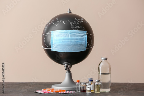 Globe with medical mask and...