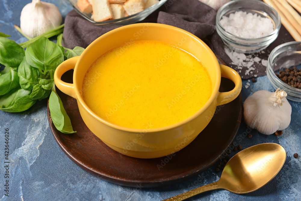 Bowl with tasty garlic cream soup on color background Bowl with tasty garlic cream soup on color background