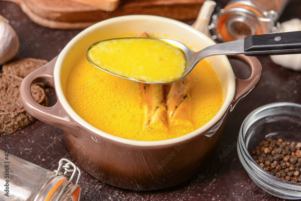 Bowl with tasty garlic cream soup on dark background Bowl with tasty garlic cream soup on dark background