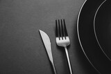 Plates and cutlery on dark background