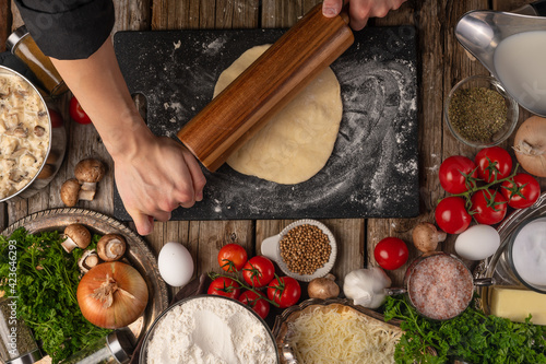 Chef prepares dough top view. Cooking pastries, culinary recipes. Ingredients and recipe book