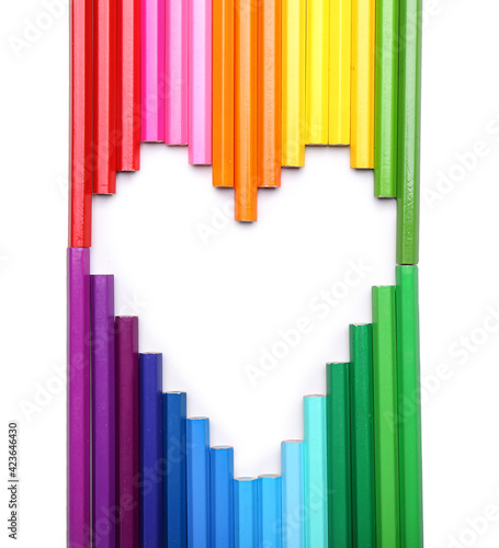 Heart shape made of colorful pencils on white background
