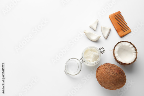 Jar with coconut oil and brush on white background
