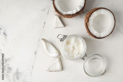 Jar with coconut oil on light background