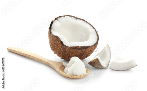 Spoon with coconut oil on white background