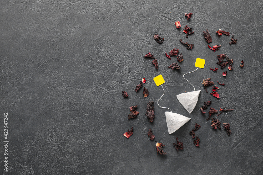 Composition with tea bags on dark background Composition with tea bags on dark background