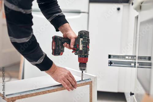 Wallpaper Mural Handyman worker assembling furniture and fixing it. Torontodigital.ca