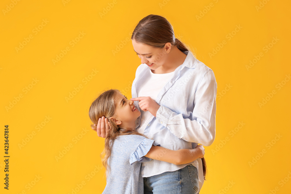 Happy woman and her little daughter on color background Happy woman and her little daughter on color background