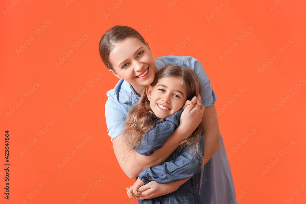 Happy woman and her little daughter on color background Happy woman and her little daughter on color background