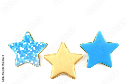 Celebratory cookies in the shape of stars covered with colored glaze