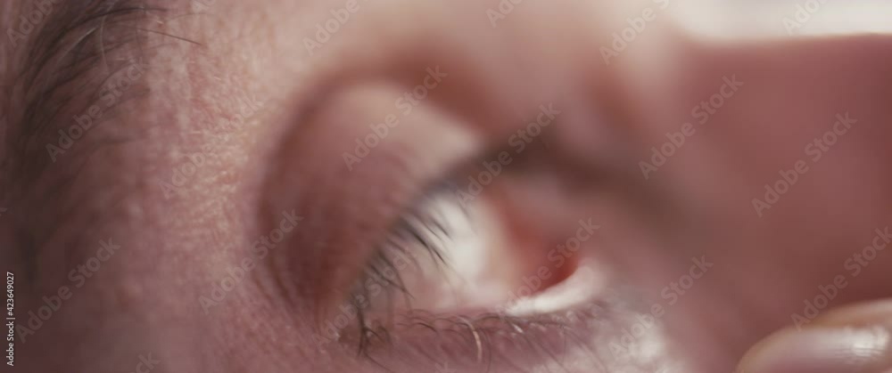 Man uses medical eye drops care in hand brown macro male close up Man uses medical eye drops care in hand brown macro male close up