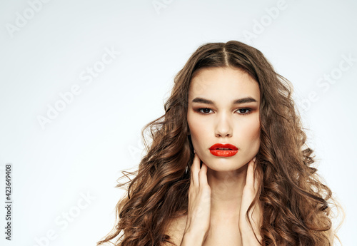 Beautiful woman red lips with eyeshadow and curly hair