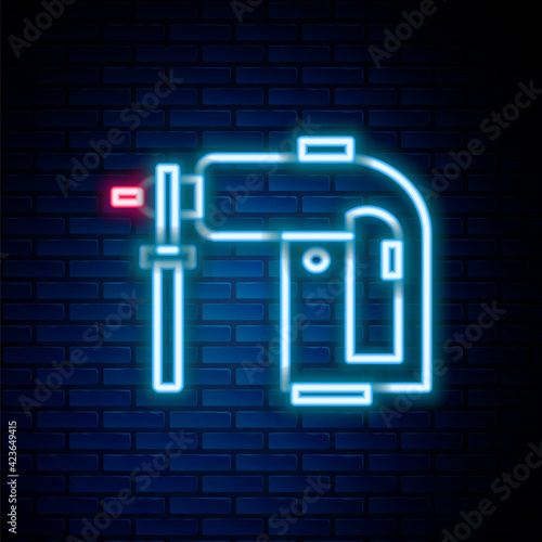 Glowing neon line Electric rotary hammer drill machine icon isolated on brick wall background. Working tool for construction, finishing, repair work. Colorful outline concept. Vector