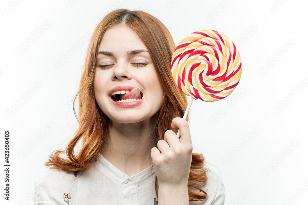 woman with multicolored round lollipop in hands sweets 