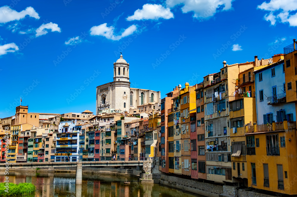 Girona, Spain - July 28, 2019: The famous Girona Cathedral seen from the Eiffel bridge in the city of Girona in Catalunya, Spain.