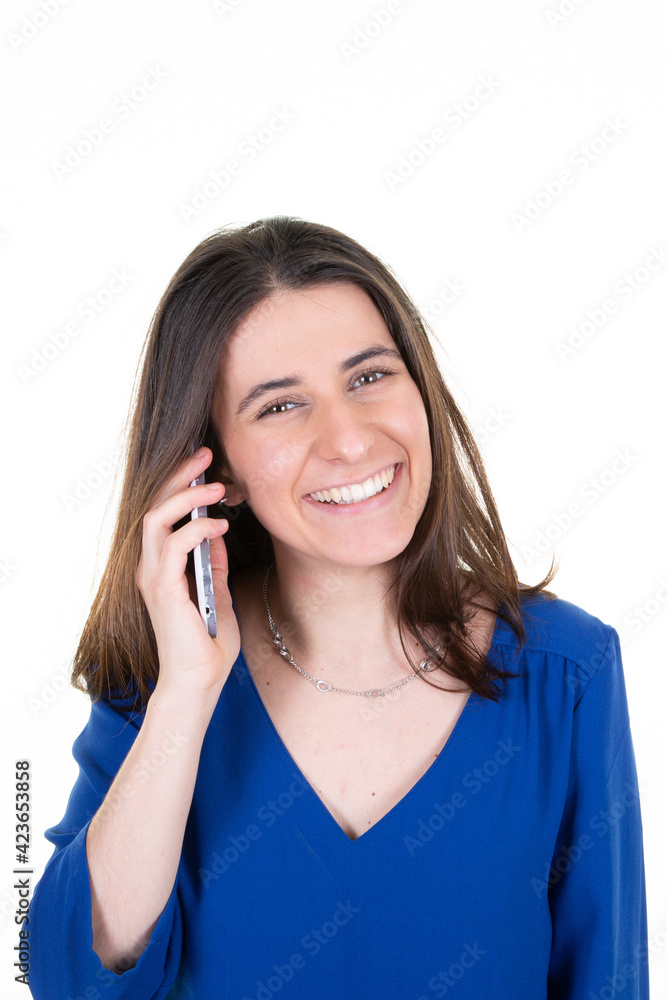 smiling young woman brunette happy talking on the phone in blue shirt on white background smiling young woman brunette happy talking on the phone in blue shirt on white background