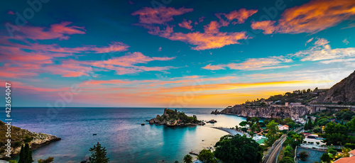Panoramic view of Isola Bella Nature Reserve at sunset. Isola Bella is a small island on the coast of Taormina, Sicily 