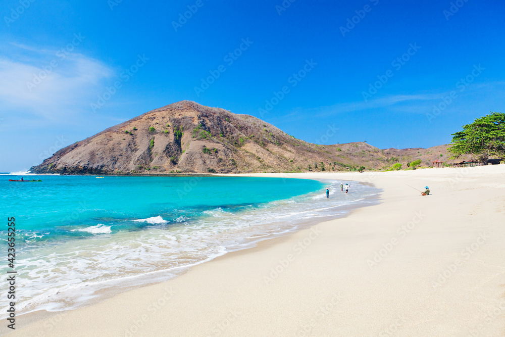 Beautiful view of turquoise water and white sand at tropical Mawun beach in Lombok, Indonesia 