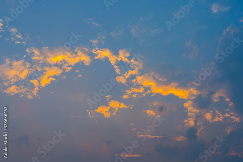 Dramatic sunset sky with orange clouds. Sky  bright blue  orange and yellow in Sunset.