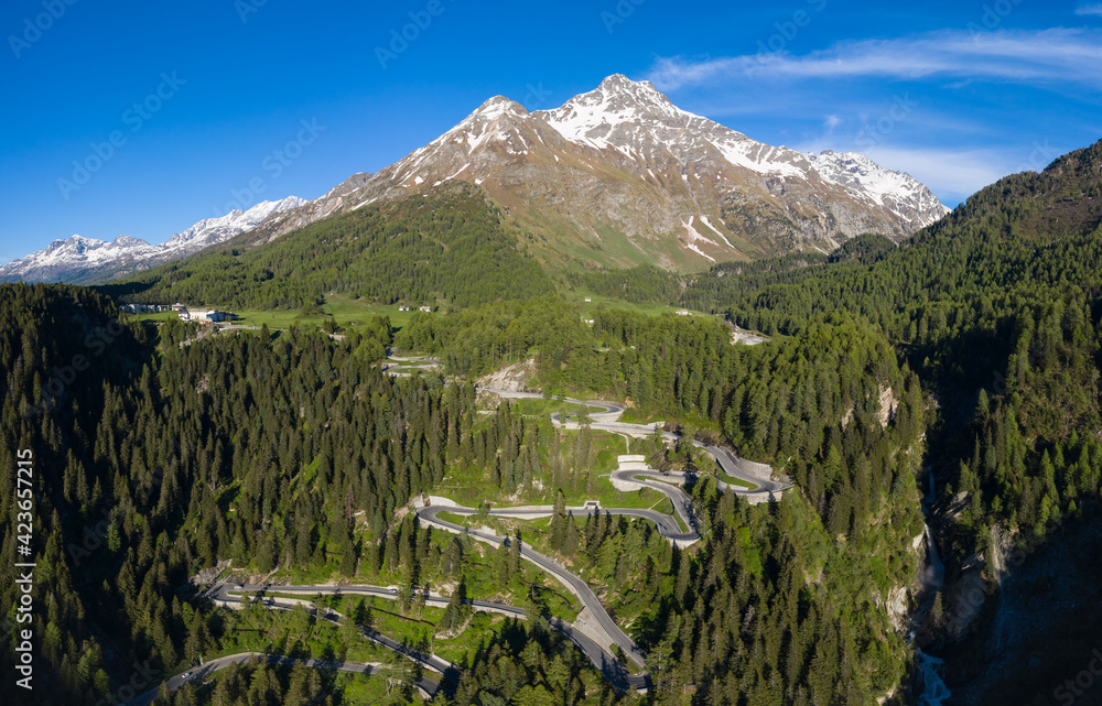 Dramatic aerial view of the Maloja mountain pass road in the Engadine valley in the alps in Canton Graubunden in Switzerland on a sunny summer day.