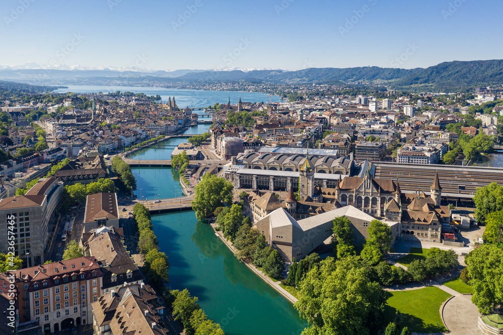 Aerial view of the Limmat river that flow through the Zurich city center by the national museum, the train station and the old town to finish in lake Zurich on a sunny summer day