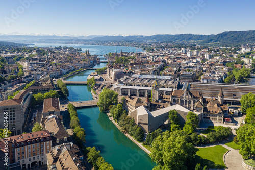 Obraz na płótnie Aerial view of the Limmat river that flow through the Zurich city center by the national museum, the train station and the old town to finish in lake Zurich on a sunny summer day w salonie