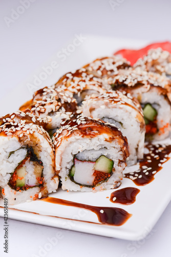 Maki Sushi Rolls made of smoked eel, cream cheese and unagi sauce. Traditional Japanese cuisine concept.