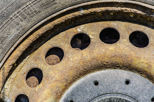 Old rusty car wheel rim closeup