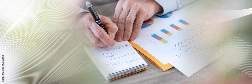 Businessman working on financial results; panoramic banner Businessman working on financial results; panoramic banner