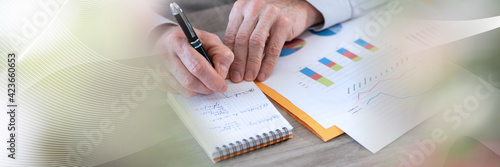 Businessman working on financial results; panoramic banner