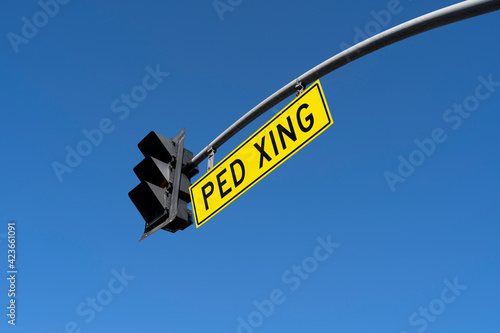 ped xing sign in a blue sky background