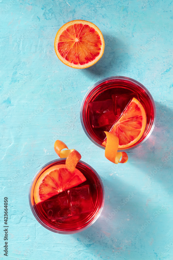 Negroni cocktail with blood oranges, shot from the top - obrazy, fototapety, plakaty 