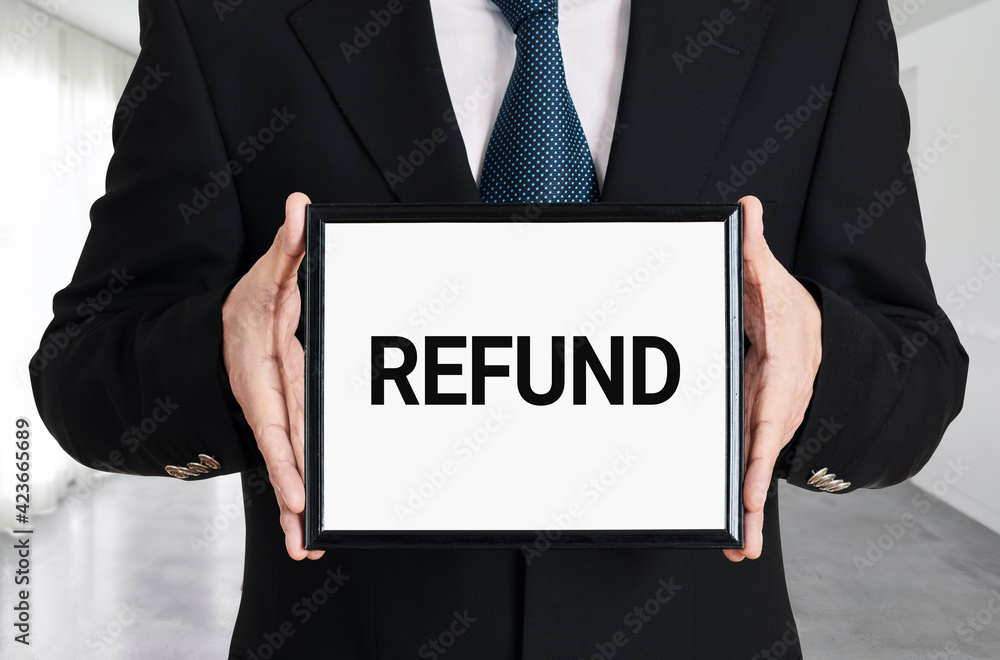 Businessman holds a signboard with the word refund. Business finance Businessman holds a signboard with the word refund. Business finance