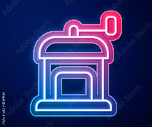 Glowing neon line Manual coffee grinder icon isolated on blue background. Vector