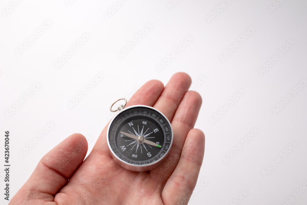 Black compass in hando n the white background Black compass in hando n the white background