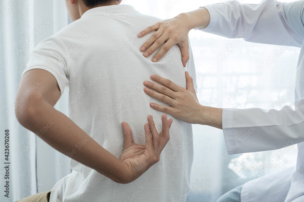 Female physiotherapists provide physical assistance to male patients with back injuries back massages for relaxation and muscle recovery in the rehabilitation center Female physiotherapists provide physical assistance to male patients with back injuries back massages for relaxation and muscle recovery in the rehabilitation center