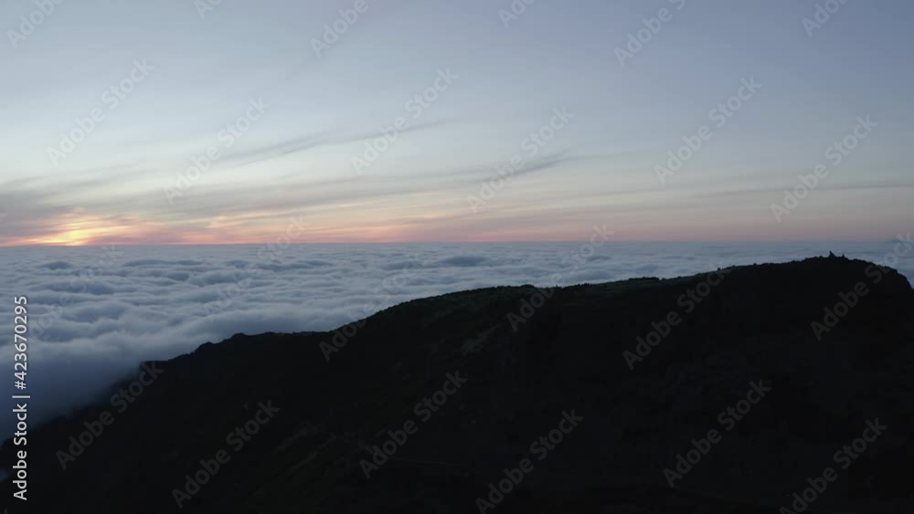 Cloud landscape with dark mountaintop of Pico Ruivo just before sunrise in Madeira Cloud landscape with dark mountaintop of Pico Ruivo just before sunrise in Madeira