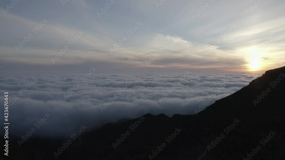 Cloud landscape with dark mountaintop of Pico Ruivo at sunrise in Madeira Cloud landscape with dark mountaintop of Pico Ruivo at sunrise in Madeira