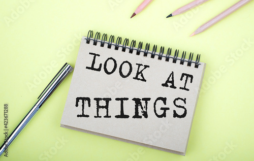 Wallpaper Mural LOOK AT THINGS text on the notebook with pen on yellow background Torontodigital.ca