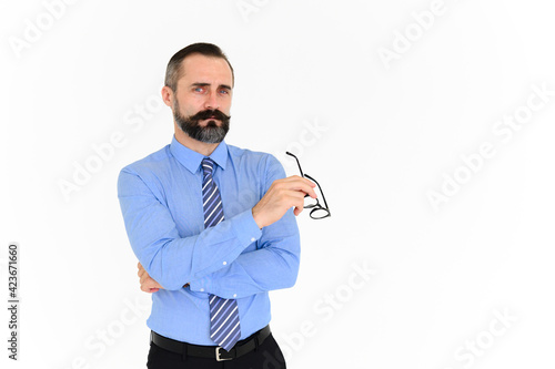 Bilde på lerret Portrait of confident middle-aged businessman in blue shirt and holding glasses