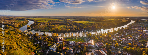 Tokaj, Hungary - Aerial panoramic view of the town of Tokaj wine region with town of Tokaj with River Tisza and golden sunrise at background on a warm autumn morning