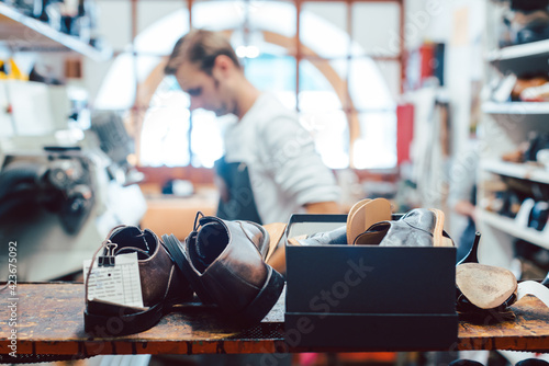 Φωτογραφία Shoemaker or cobbler in his traditional workshop