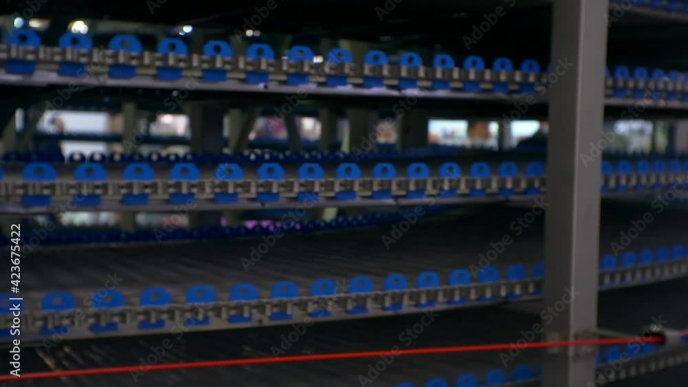 Automatic round multilevel conveyor machine in a bakery. Close-up Automatic round multilevel conveyor machine in a bakery. Close-up