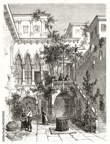 elegant courtyard with stairway, well and pergola in Salviati Palace, Venice, Italy. Ancient grey tone etching style art by Girardet, Le Tour du Monde, 1862 photo