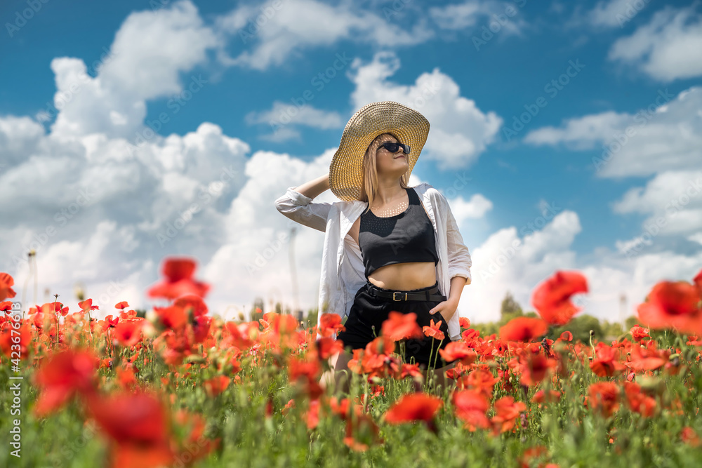 Portrait of young girl walking in poppy field at summer time Portrait of young girl walking in poppy field at summer time