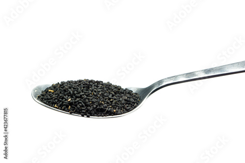 Real black caraway on spoon isolated on white background