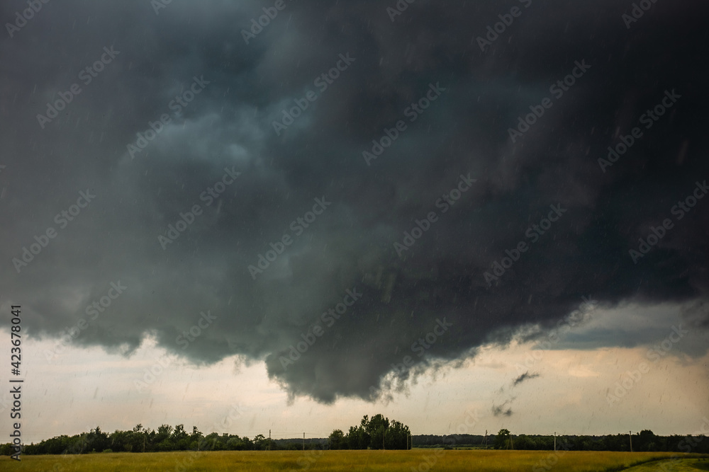 Supercell storm clouds with wall cloud and intense rain Supercell storm clouds with wall cloud and intense rain