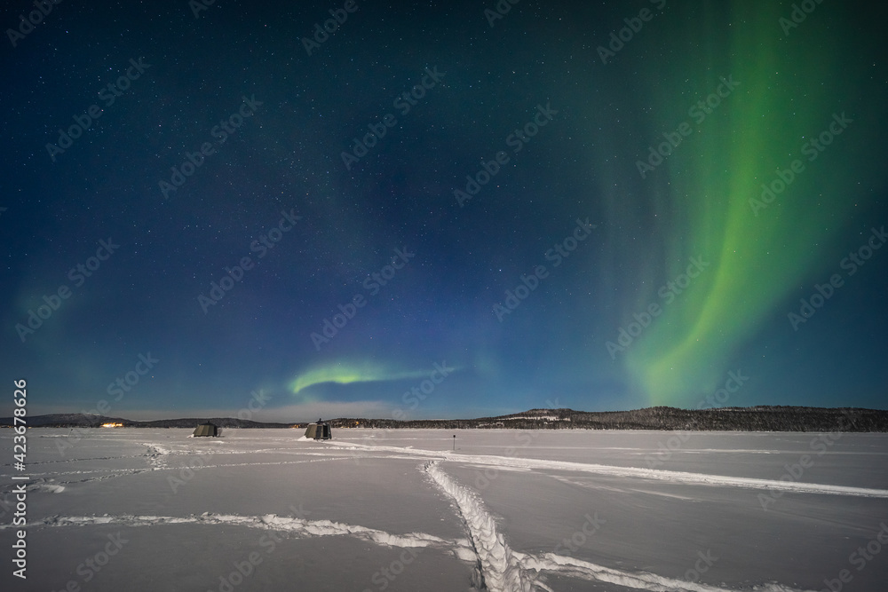 The northern lights over a frozen river in Swedish Lapland