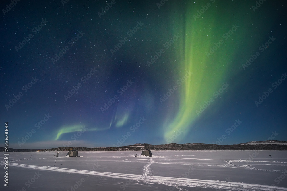 The northern lights over a frozen river in Swedish Lapland