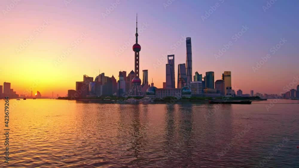 Time-lapse view of modern landmark buildings and moving ships in Shanghai, China at sunrise Time-lapse view of modern landmark buildings and moving ships in Shanghai, China at sunrise